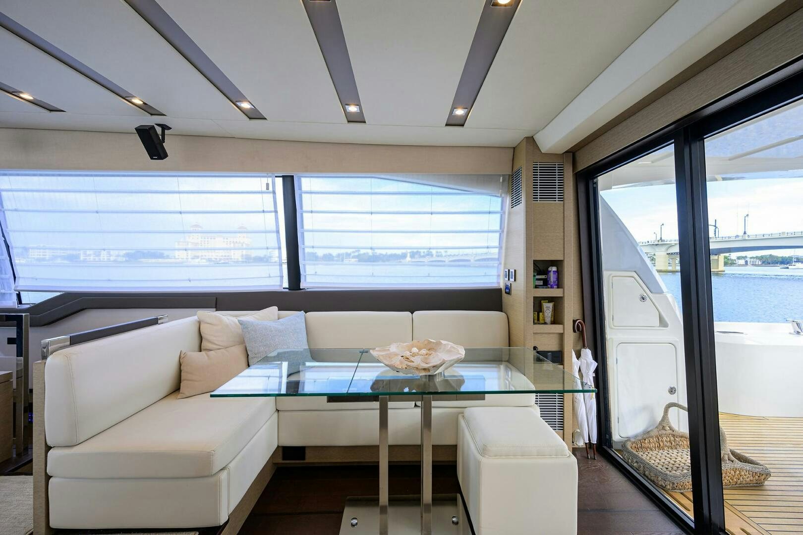 a living room with a large window aboard 2016 68 PRESTIGE Yacht for Sale