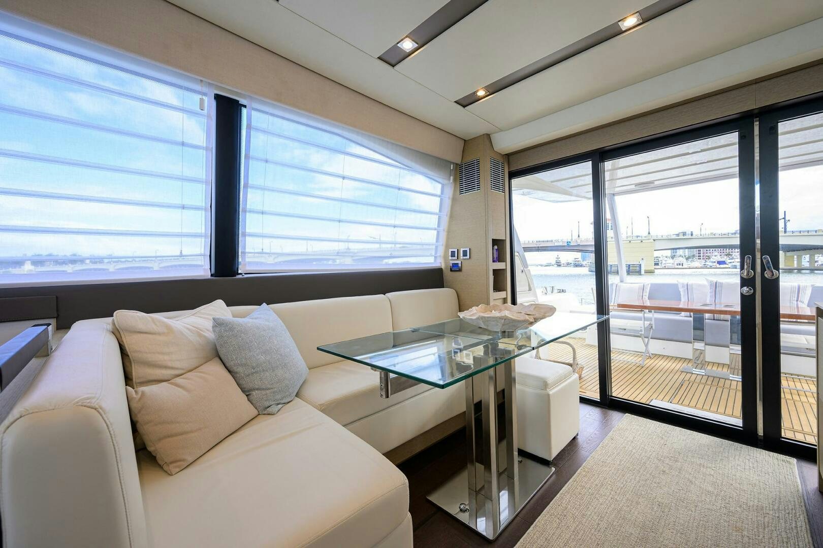 a room with a table and couch aboard 2016 68 PRESTIGE Yacht for Sale
