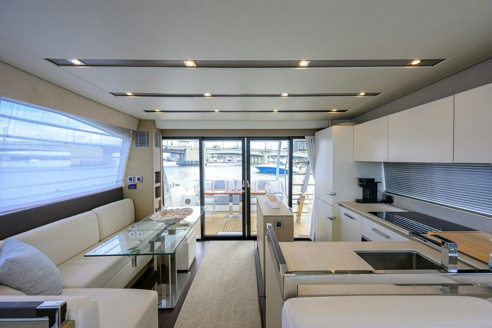 a living room with a large window aboard 2016 68 PRESTIGE Yacht for Sale