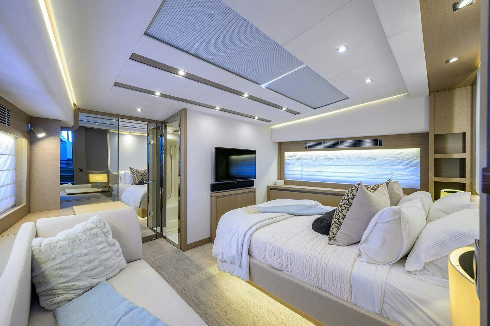 a room with a bed and a television aboard 2016 68 PRESTIGE Yacht for Sale