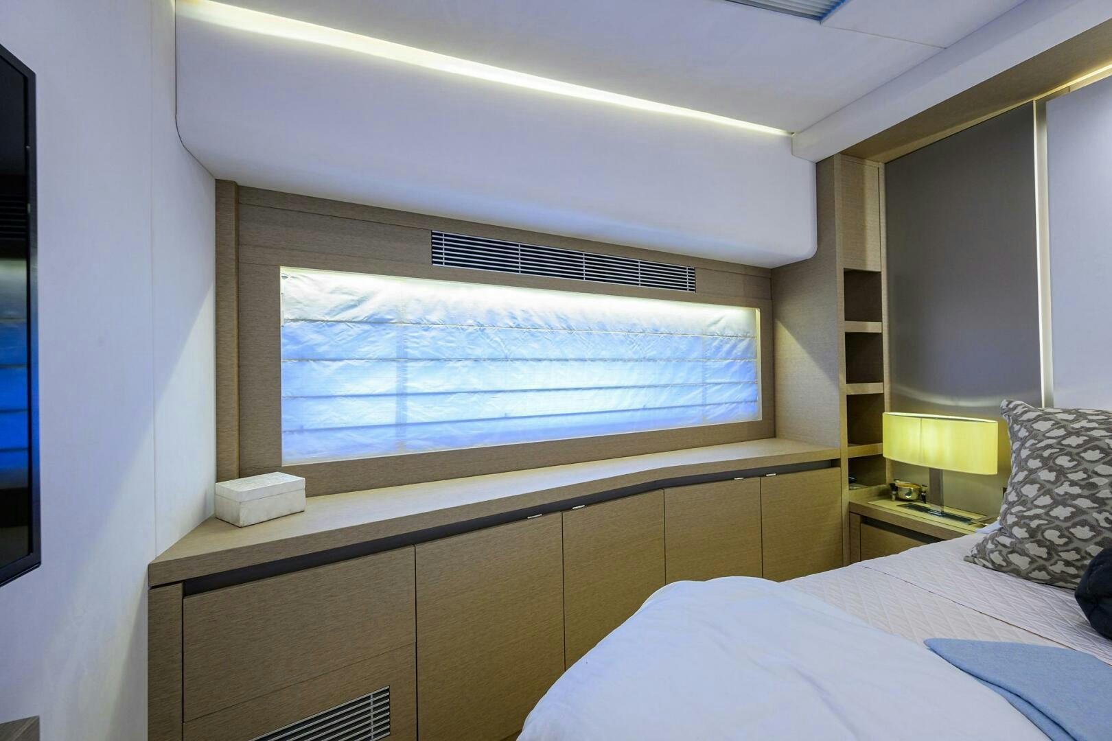a room with a bed and a window aboard 2016 68 PRESTIGE Yacht for Sale