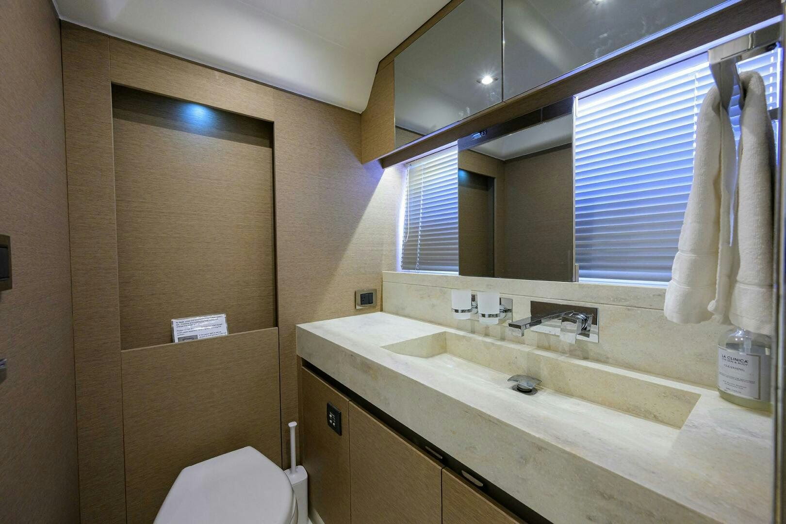 a bathroom with a sink and a mirror aboard 2016 68 PRESTIGE Yacht for Sale