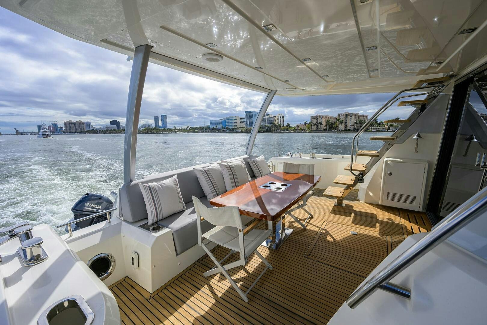 a deck with a table and chairs on it aboard 2016 68 PRESTIGE Yacht for Sale