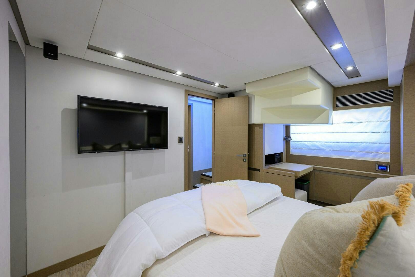 a bedroom with a tv on the wall aboard 2016 68 PRESTIGE Yacht for Sale