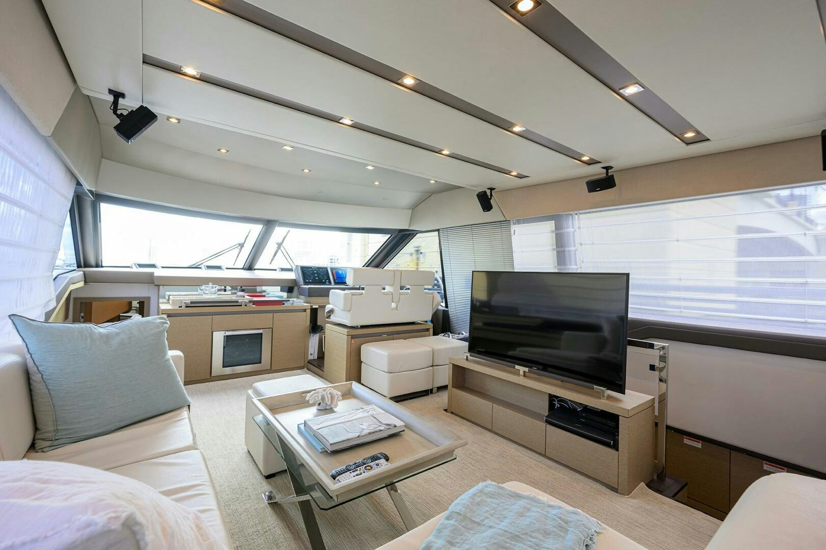 a living room with a tv and a couch aboard 2016 68 PRESTIGE Yacht for Sale