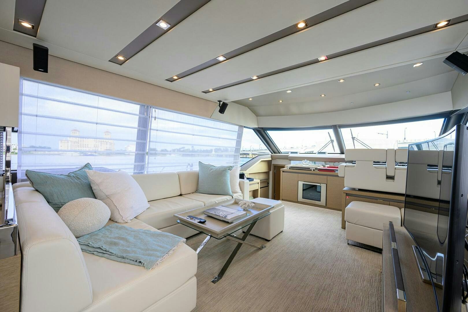a living room with a couch and a table aboard 2016 68 PRESTIGE Yacht for Sale