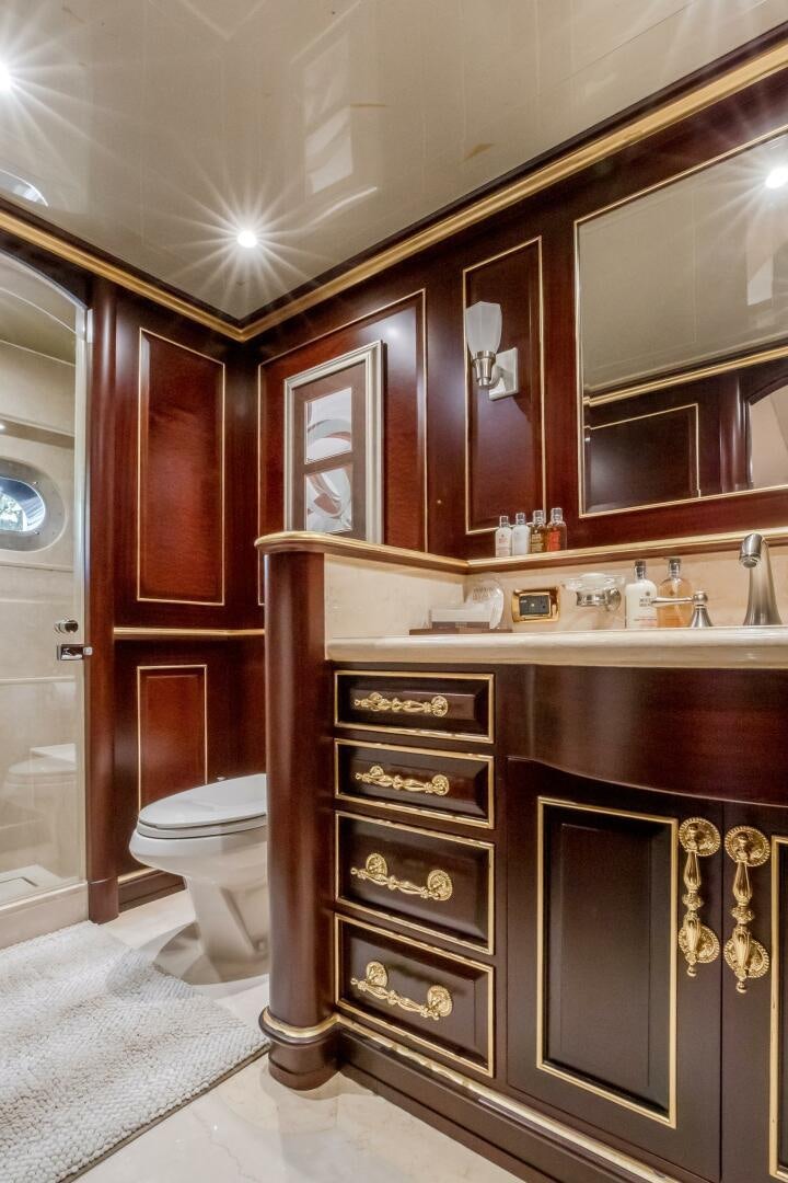 a bathroom with a vanity and mirror aboard STATUS QUO Yacht for Sale