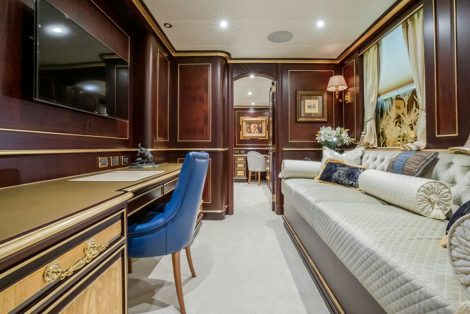 a room with a bed and desk aboard STATUS QUO Yacht for Sale