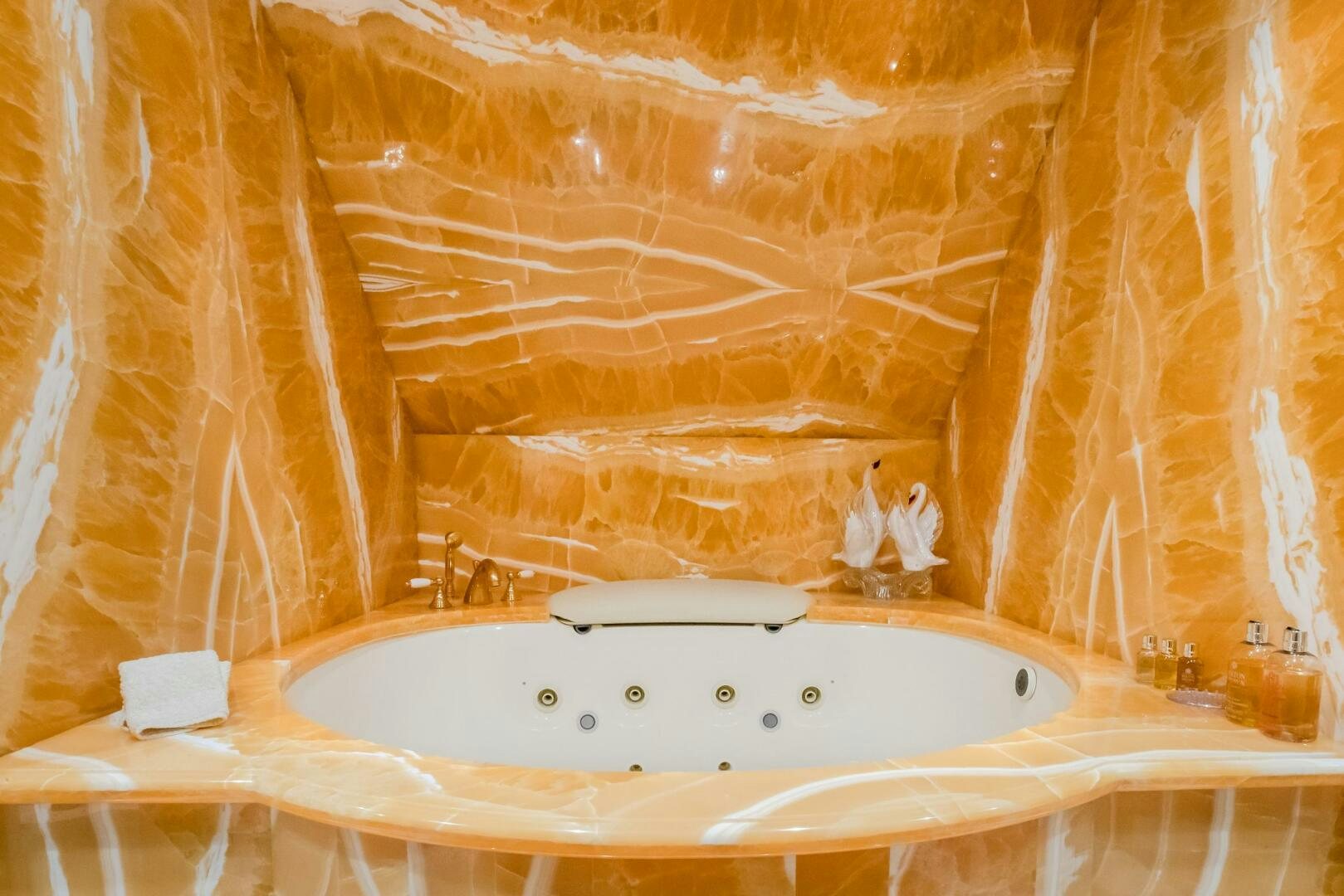 a bathroom with a bathtub and shower curtain aboard STATUS QUO Yacht for Sale