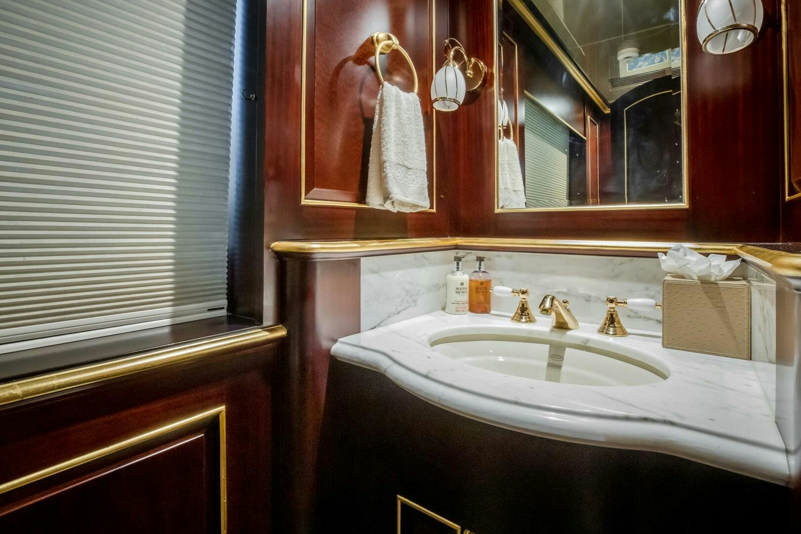 a bathroom with a mirror and a sink aboard STATUS QUO Yacht for Sale