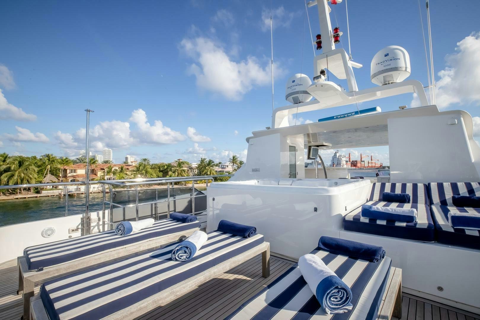 a large white boat with a blue roof and a white boat on the water aboard STATUS QUO Yacht for Sale