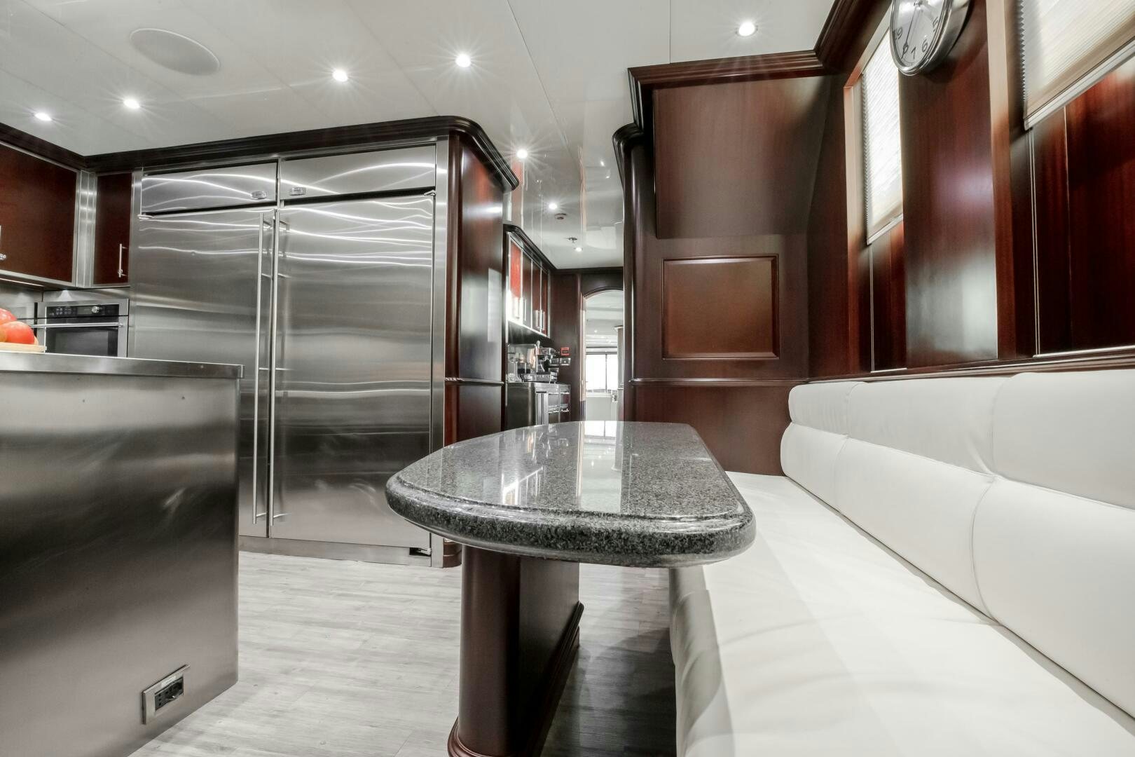 a room with a table and a couch aboard STATUS QUO Yacht for Sale