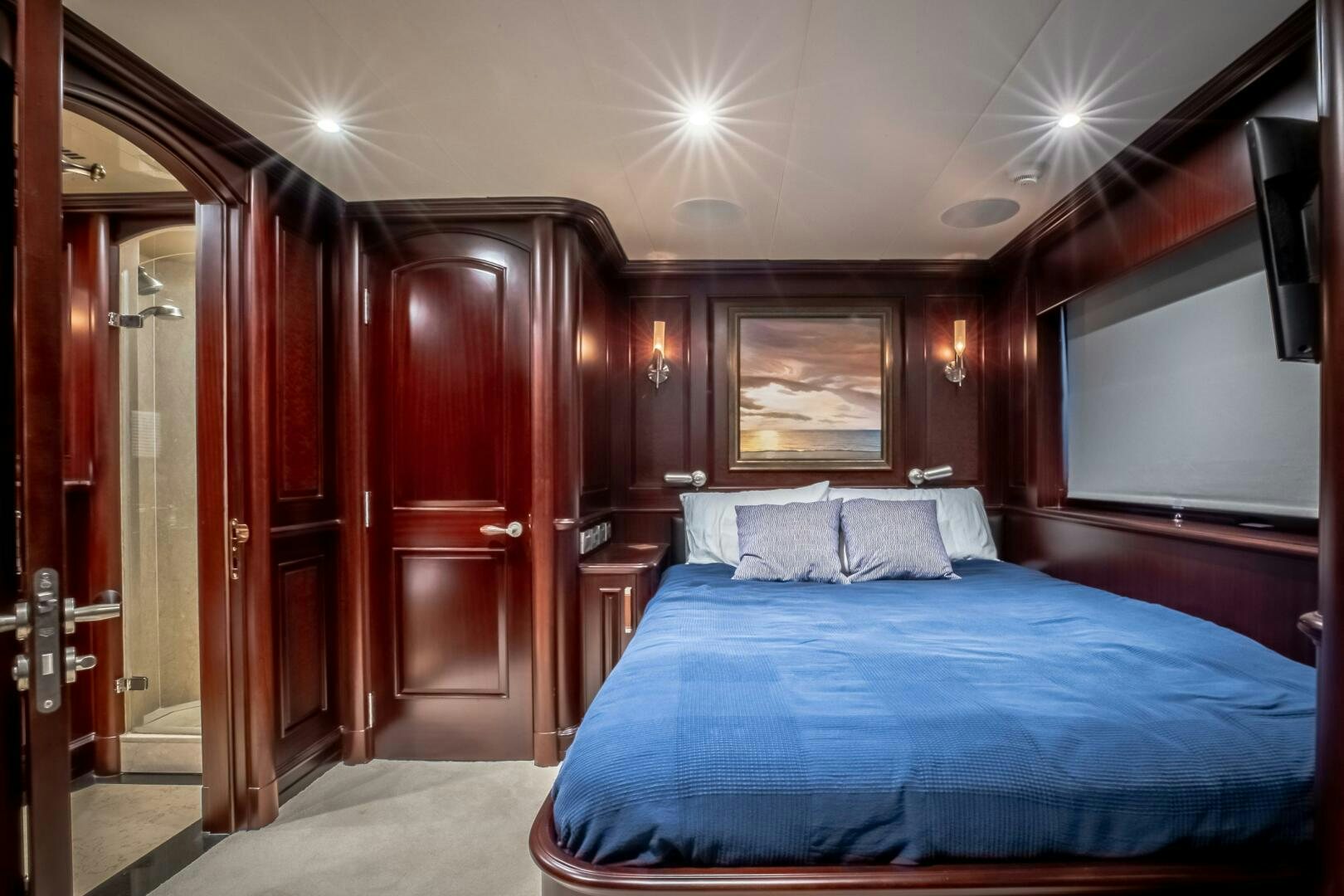 a bedroom with a bed and a wood door aboard STATUS QUO Yacht for Sale