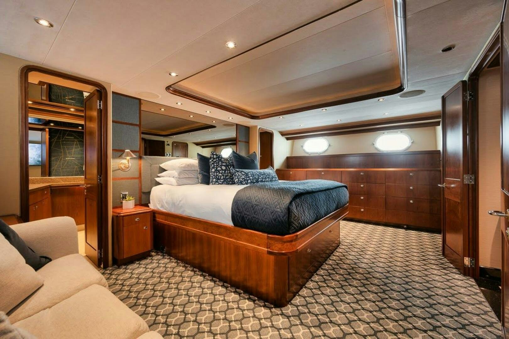 a bedroom with a bed and a couch aboard SLEEPOVER Yacht for Sale