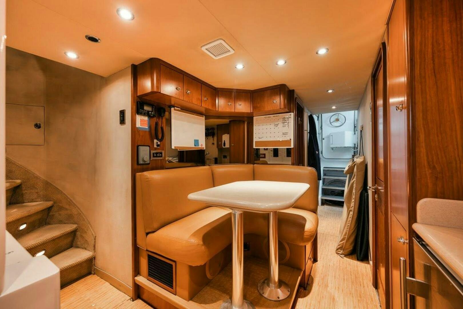a kitchen with a table and chairs aboard SLEEPOVER Yacht for Sale