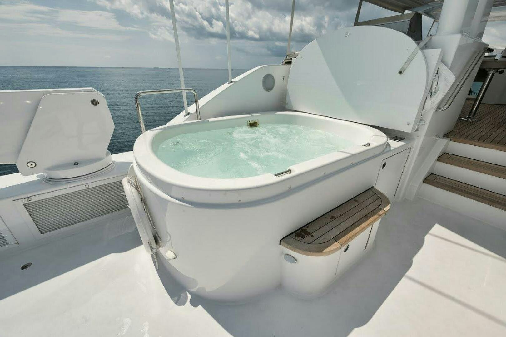 a white bathtub with a wooden seat and a wooden bench on a boat aboard SLEEPOVER Yacht for Sale