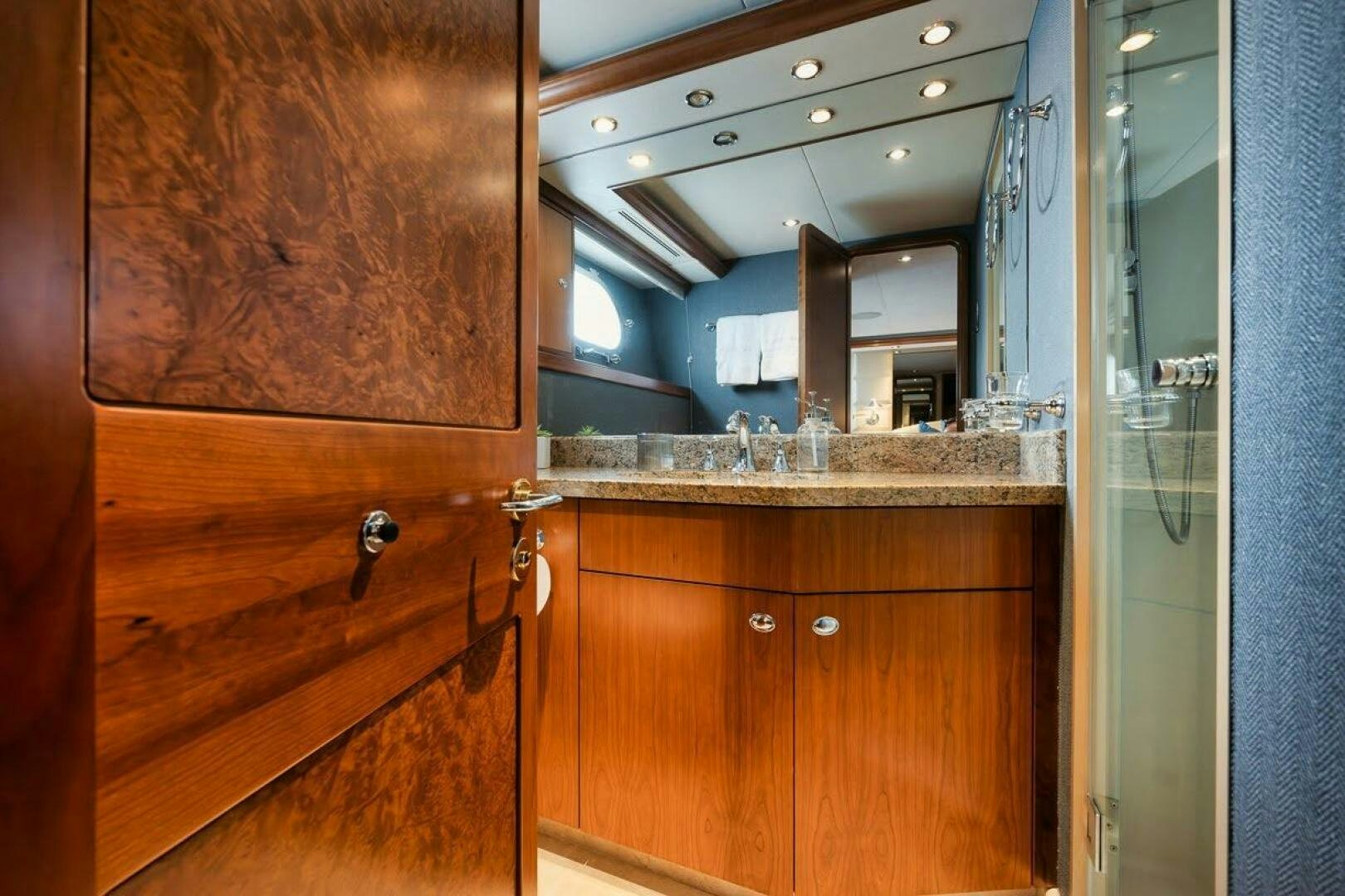 a bathroom with a countertop sink and cabinets aboard SLEEPOVER Yacht for Sale