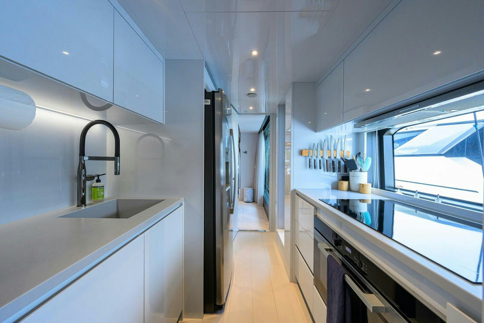 a kitchen with a sink and cabinets aboard 90 RIVA 2023 Yacht for Sale