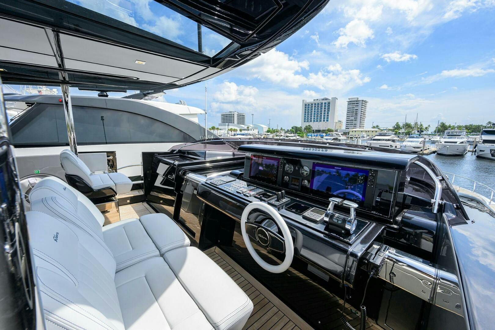 a boat with a view of a city and water below aboard 90 RIVA 2023 Yacht for Sale