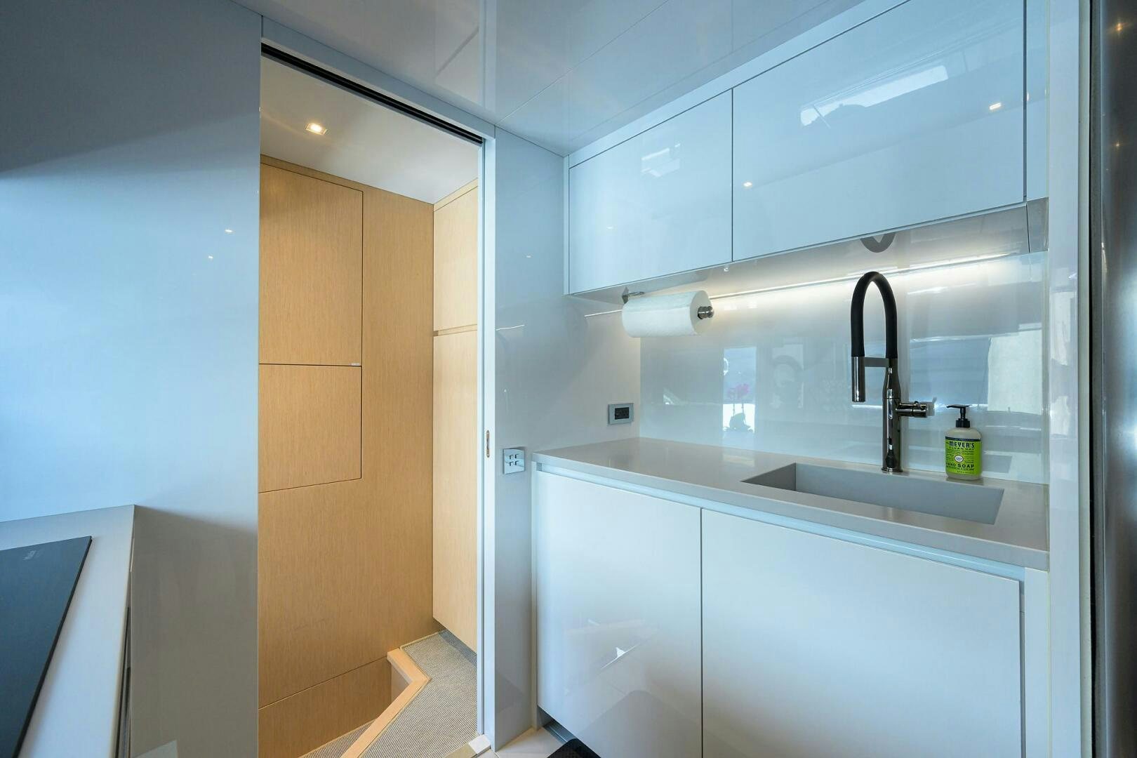 a kitchen with a sink and cabinets aboard 90 RIVA 2023 Yacht for Sale