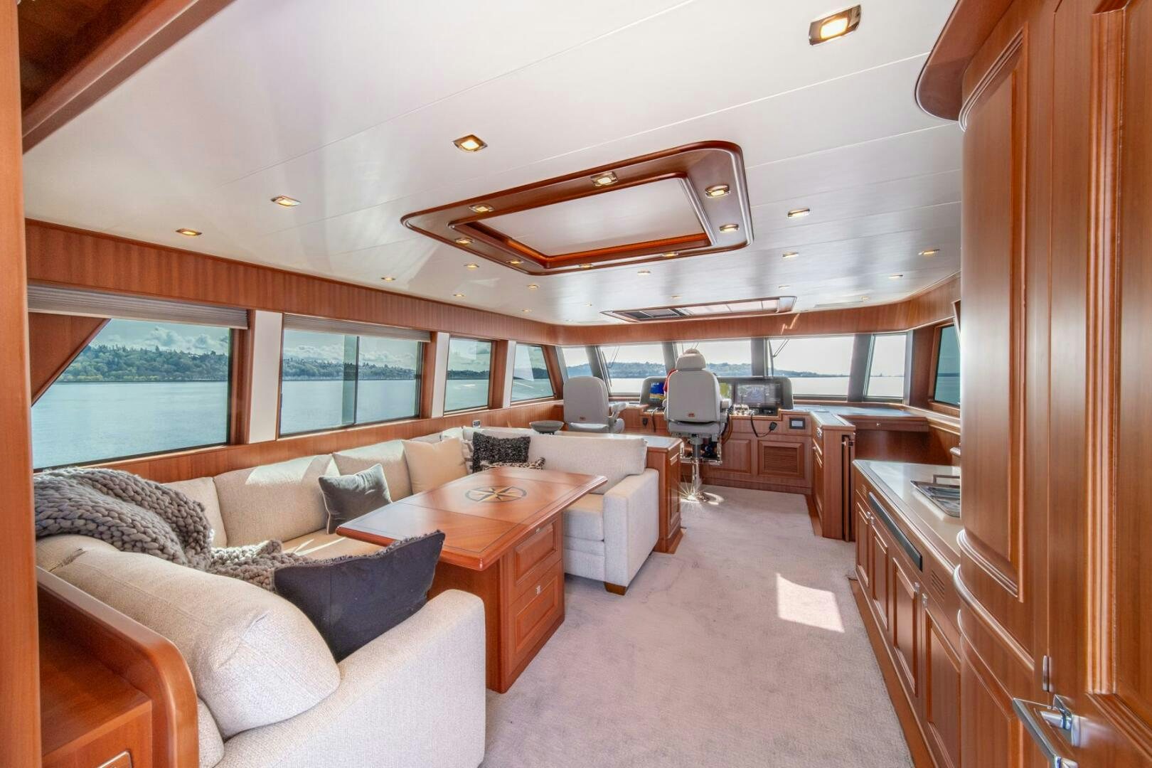 a living room with a couch and a table aboard ABRI SUR LA MER Yacht for Sale