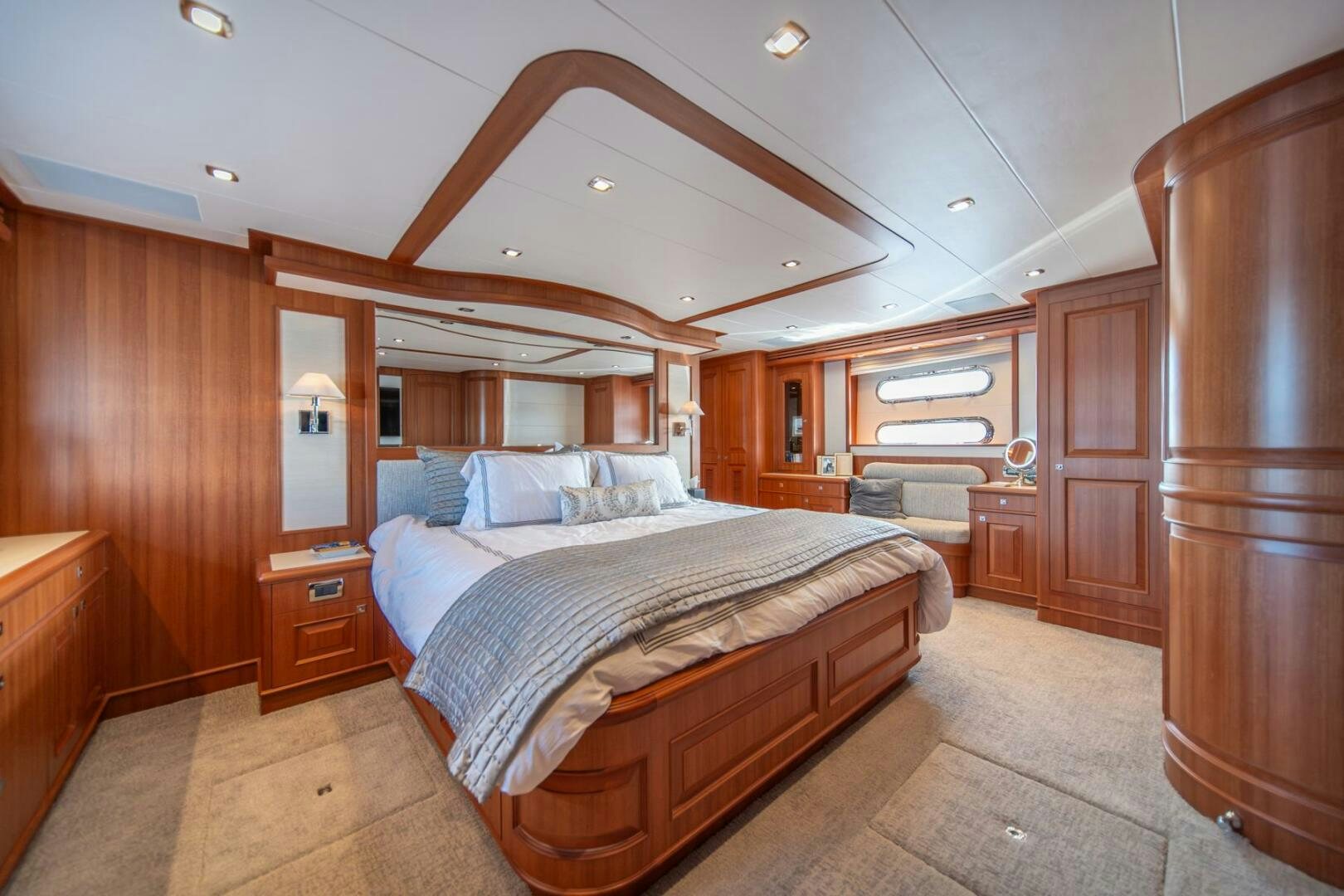 a bedroom with a bed and a wood closet aboard ABRI SUR LA MER Yacht for Sale
