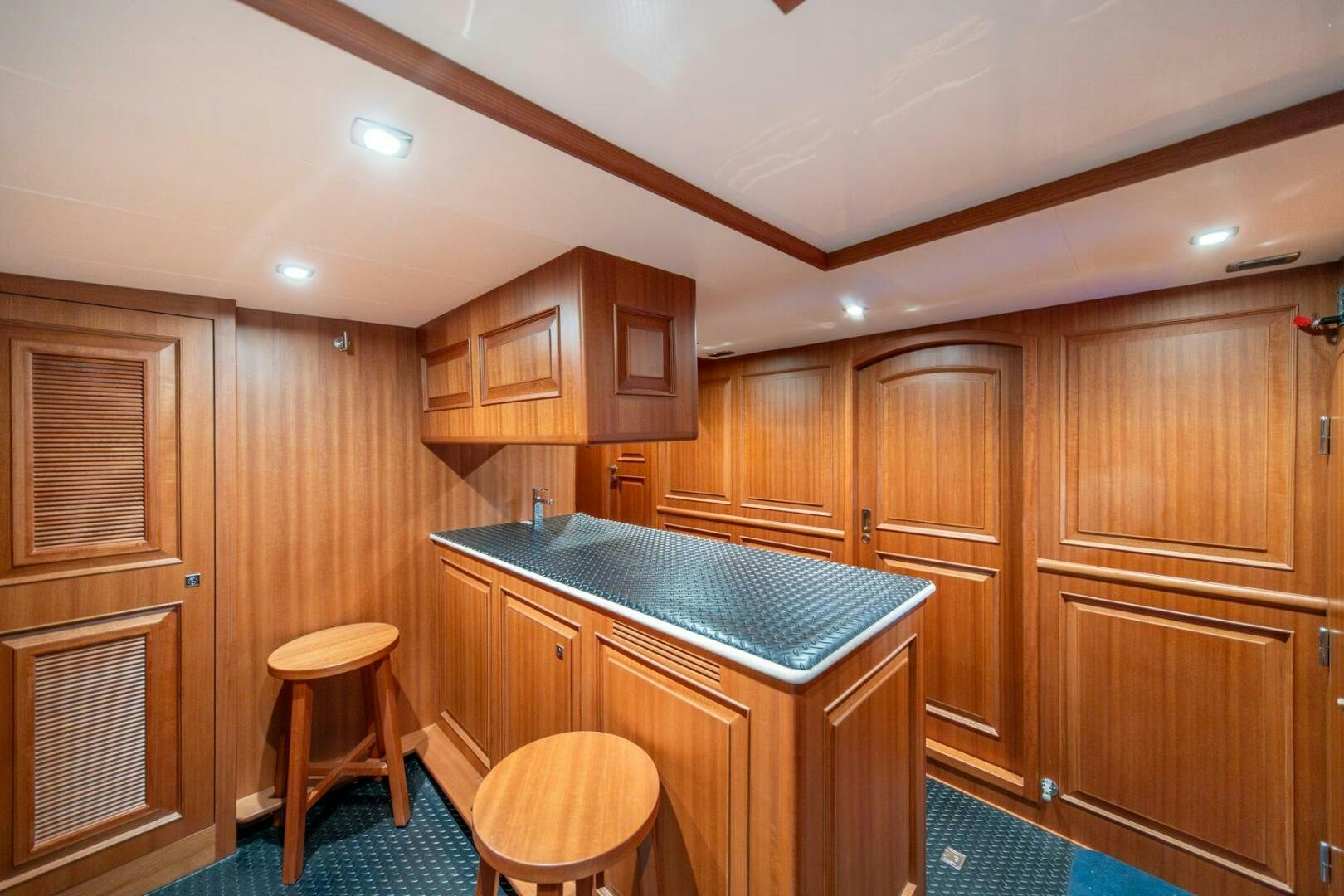 a kitchen with wooden cabinets aboard ABRI SUR LA MER Yacht for Sale