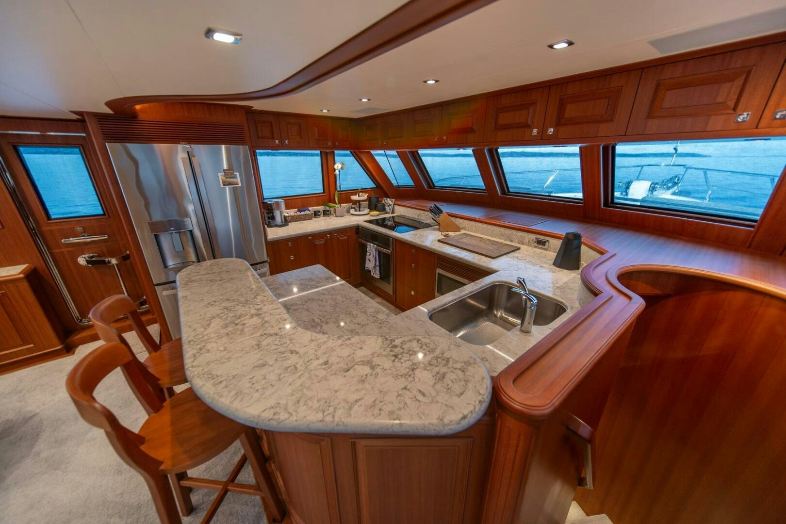 a kitchen with a table and chairs aboard ABRI SUR LA MER Yacht for Sale