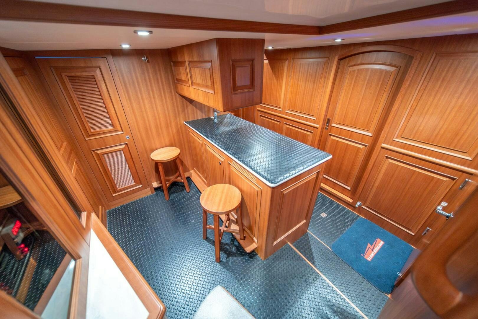 a kitchen with a bar and stools aboard ABRI SUR LA MER Yacht for Sale
