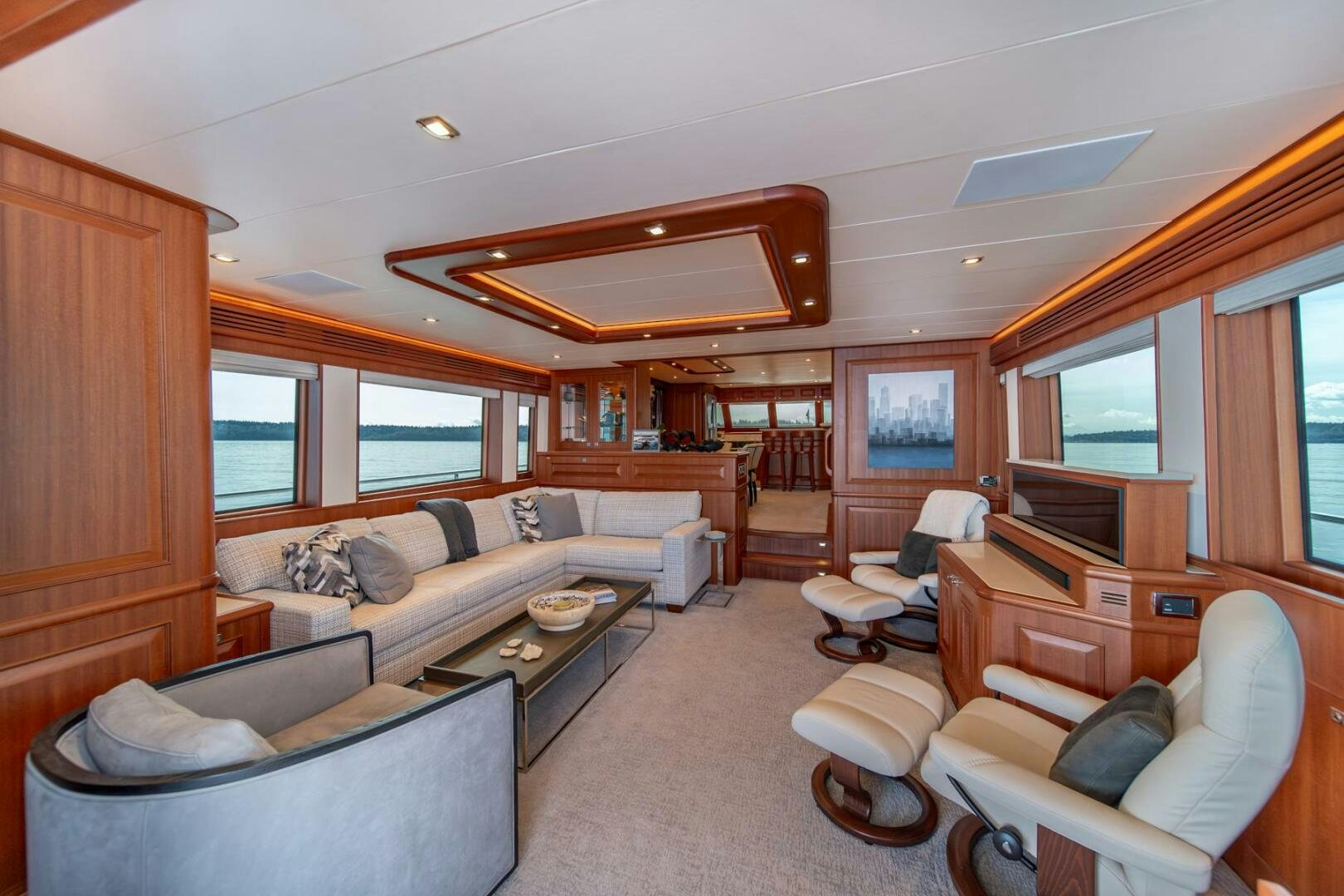 a living room with a couch and a television aboard ABRI SUR LA MER Yacht for Sale