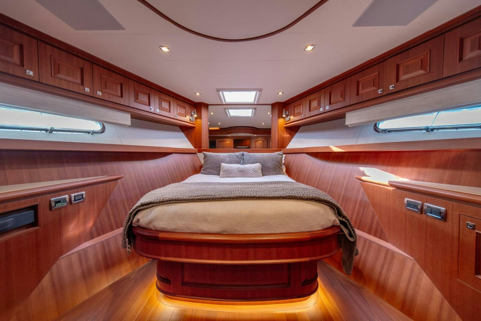a room with wooden cabinets and a bed aboard ABRI SUR LA MER Yacht for Sale