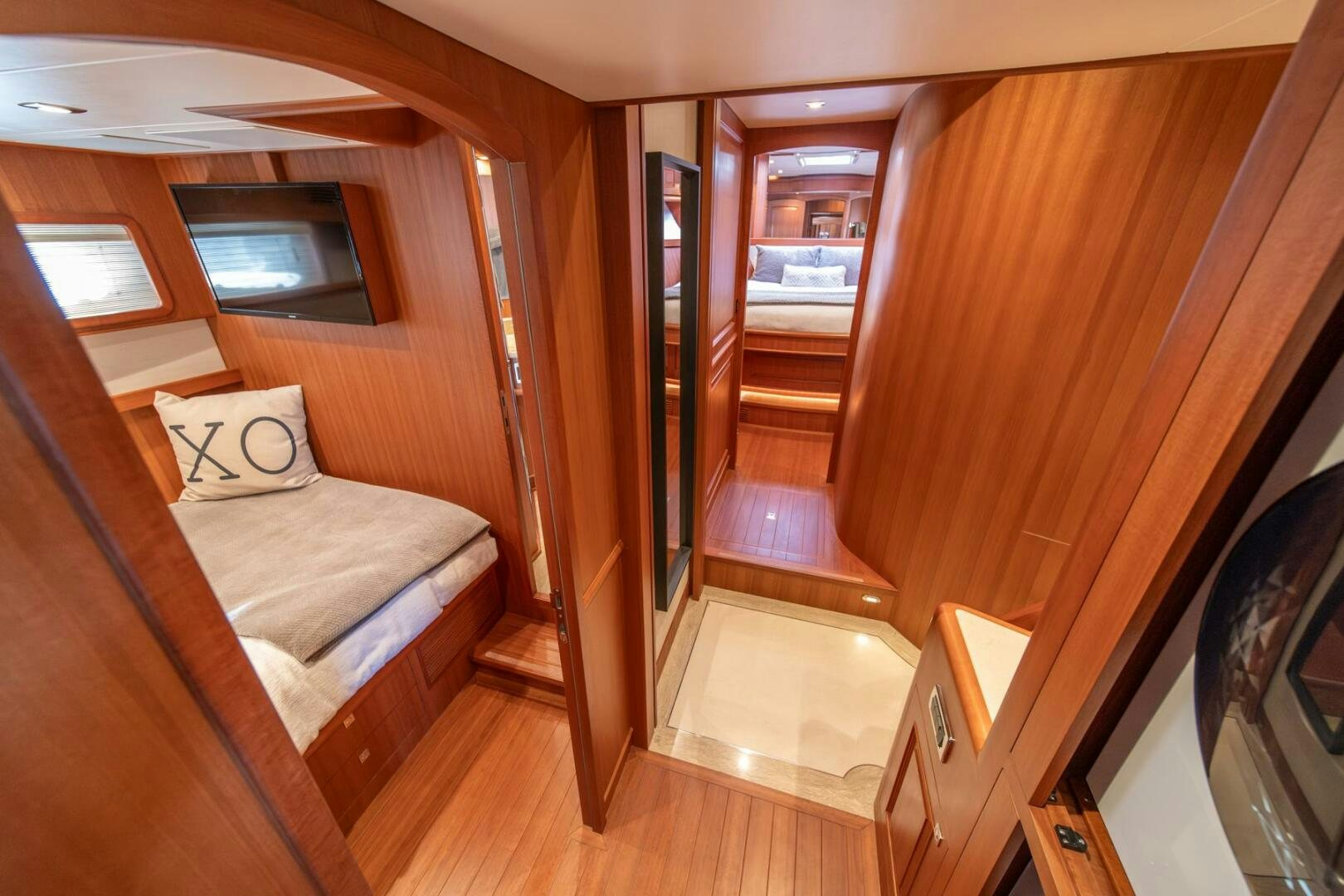 a room with a bed and a wood door aboard ABRI SUR LA MER Yacht for Sale