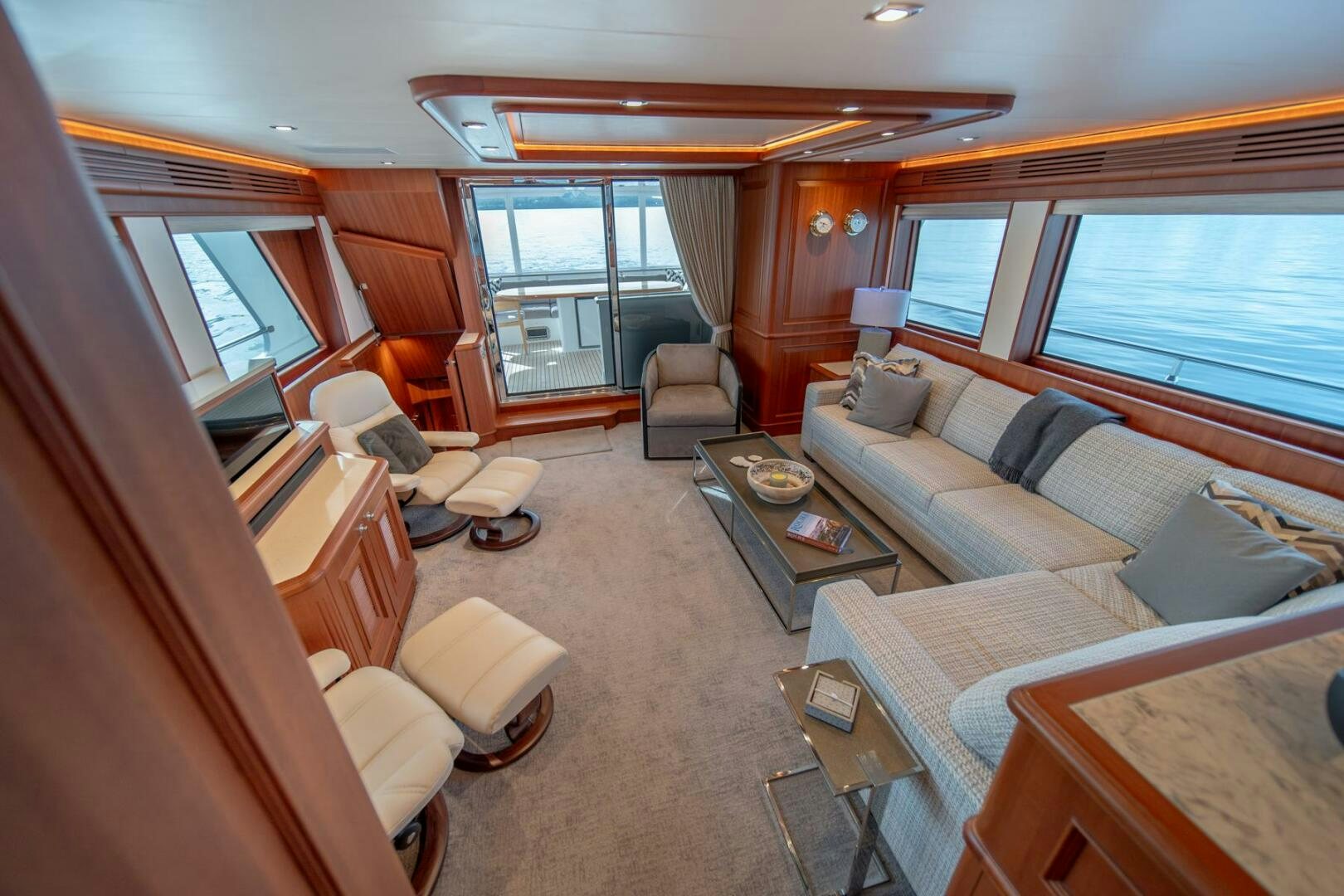 a living room with a couch and a table aboard ABRI SUR LA MER Yacht for Sale