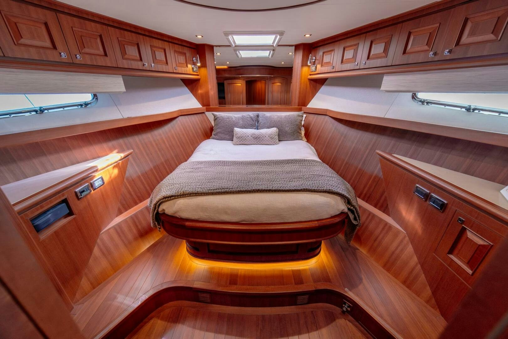 a room with a bed and wooden cabinets aboard ABRI SUR LA MER Yacht for Sale