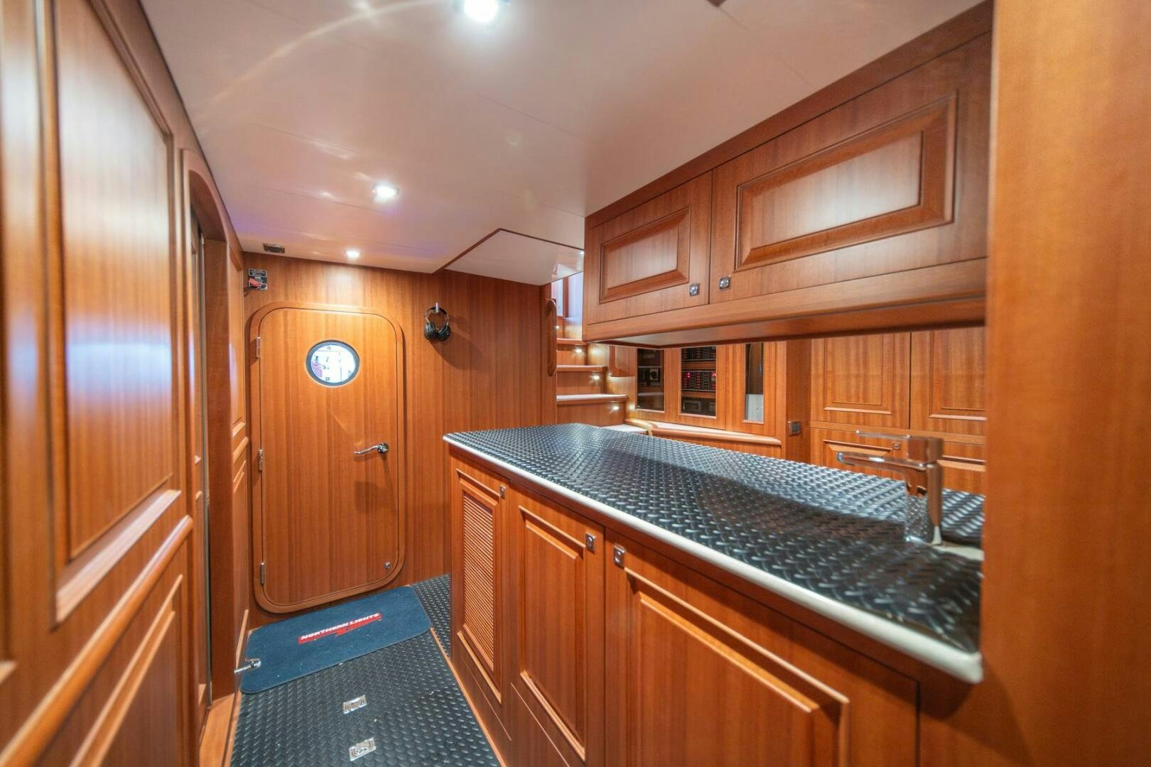 a kitchen with wooden cabinets aboard ABRI SUR LA MER Yacht for Sale