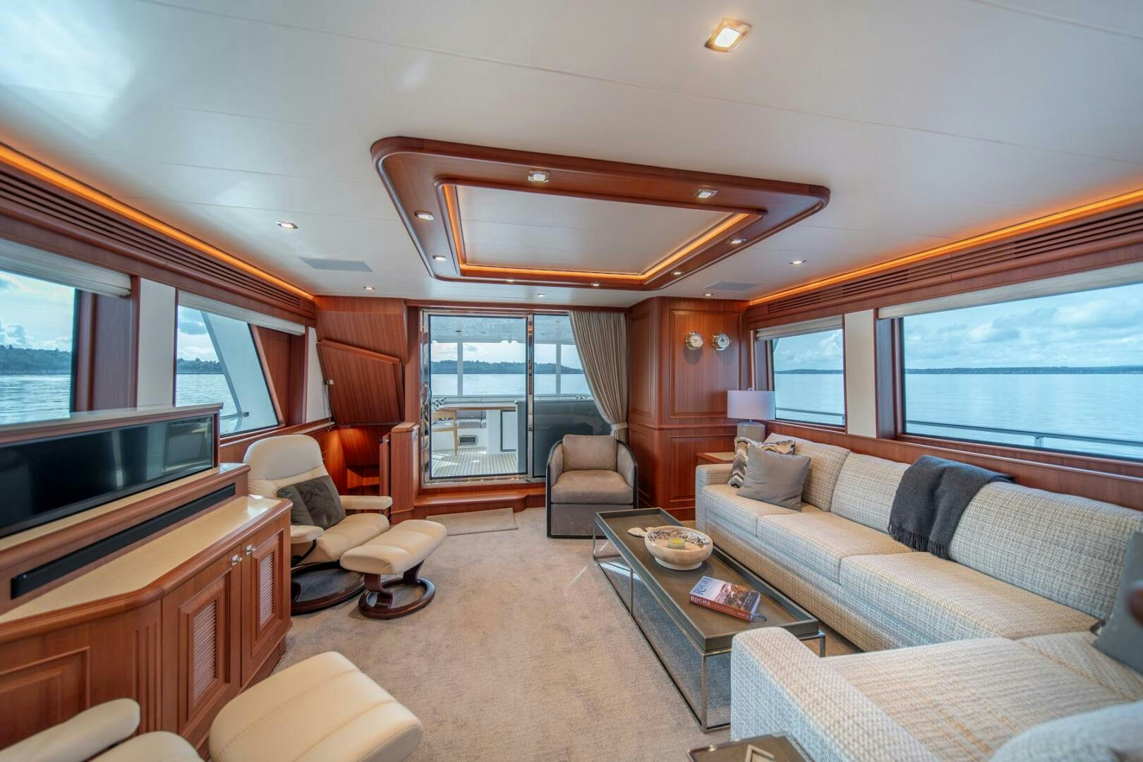 a living room with a couch and a television aboard ABRI SUR LA MER Yacht for Sale