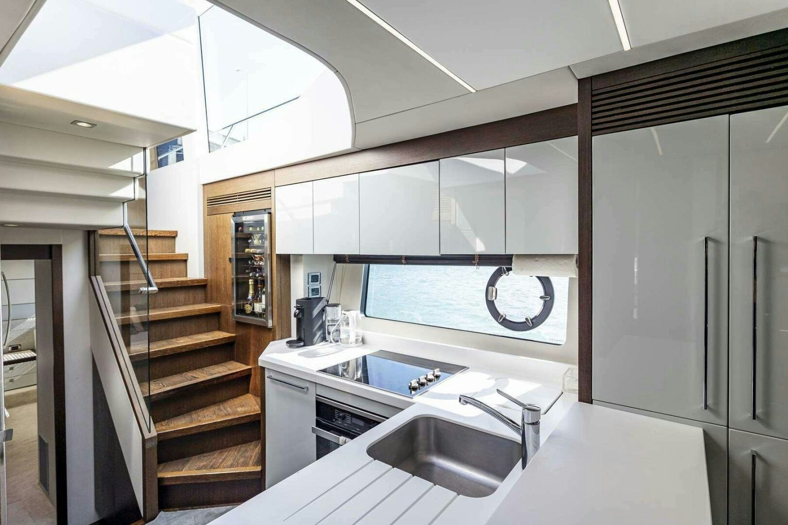 a kitchen with a sink and cabinets aboard H Yacht for Sale