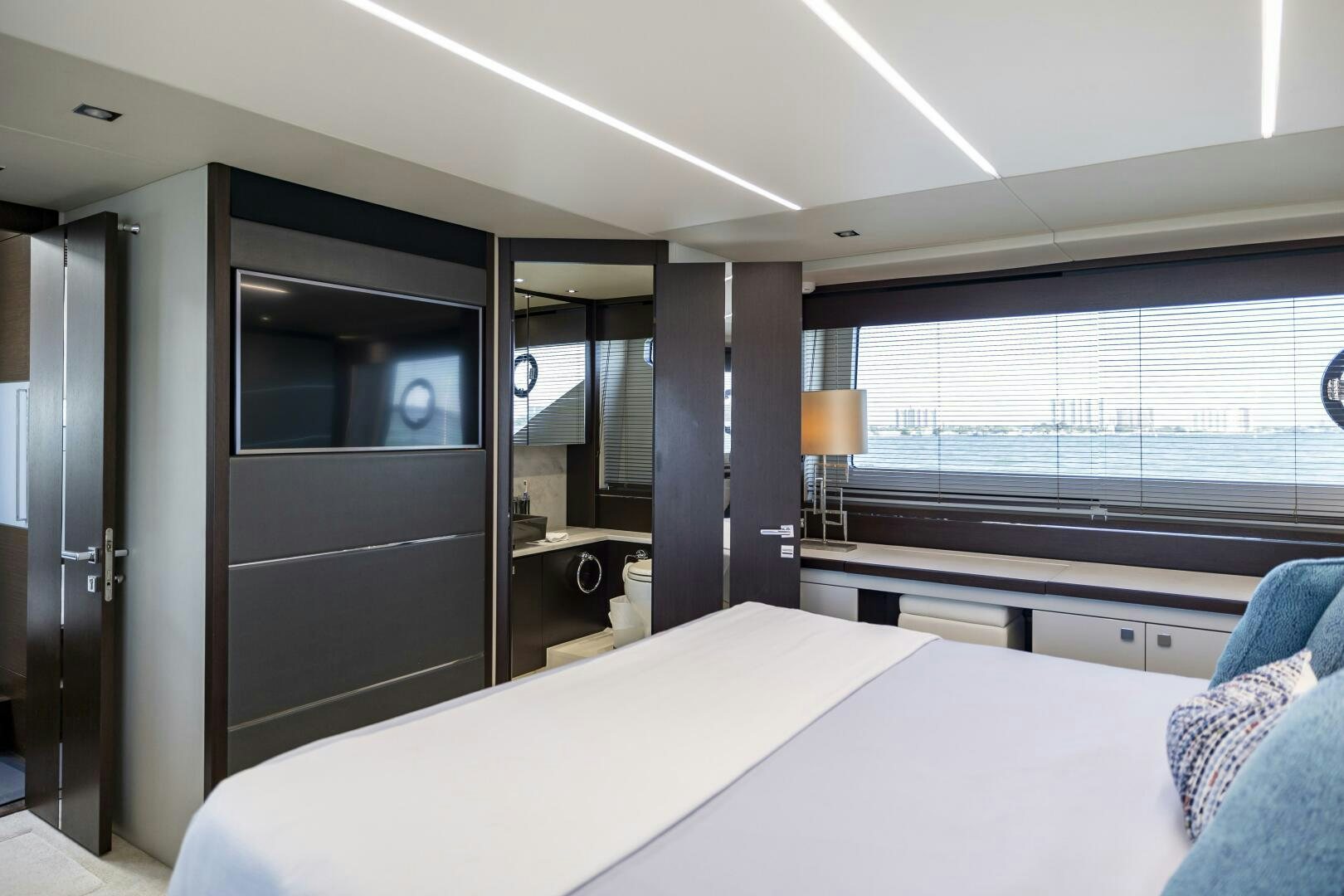 a room with a bed and a desk aboard H Yacht for Sale