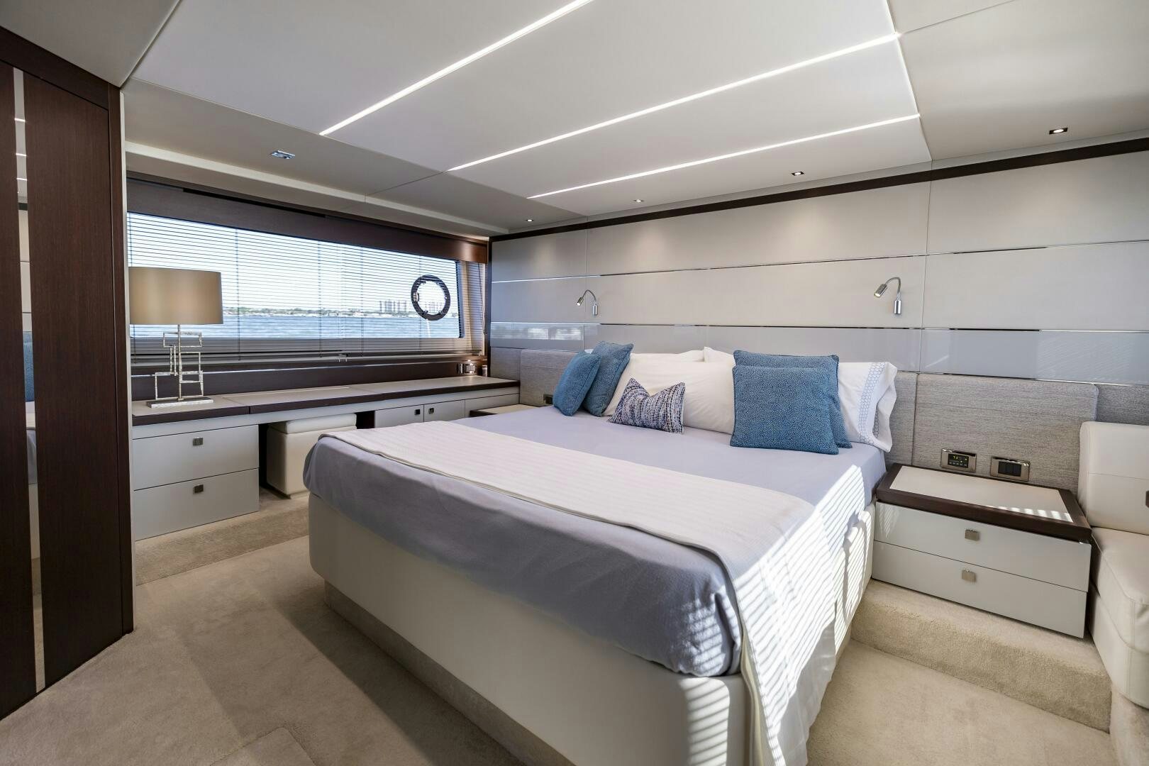 a bedroom with a bed and a window aboard H Yacht for Sale