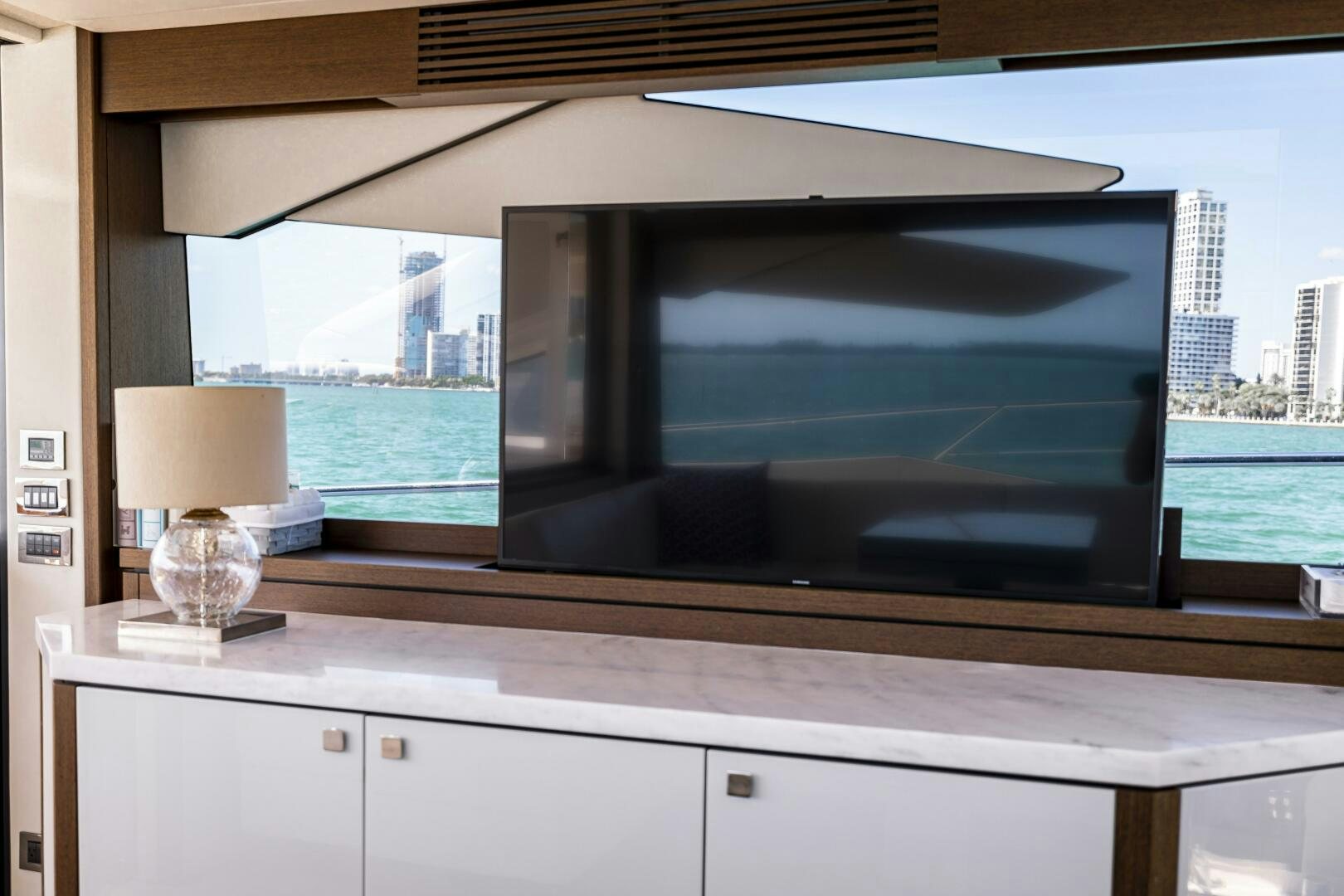 a large television screen aboard H Yacht for Sale
