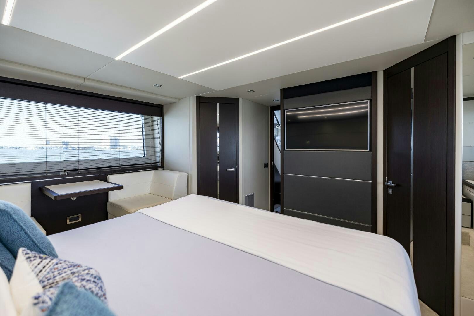 a bedroom with a bed and a desk aboard H Yacht for Sale