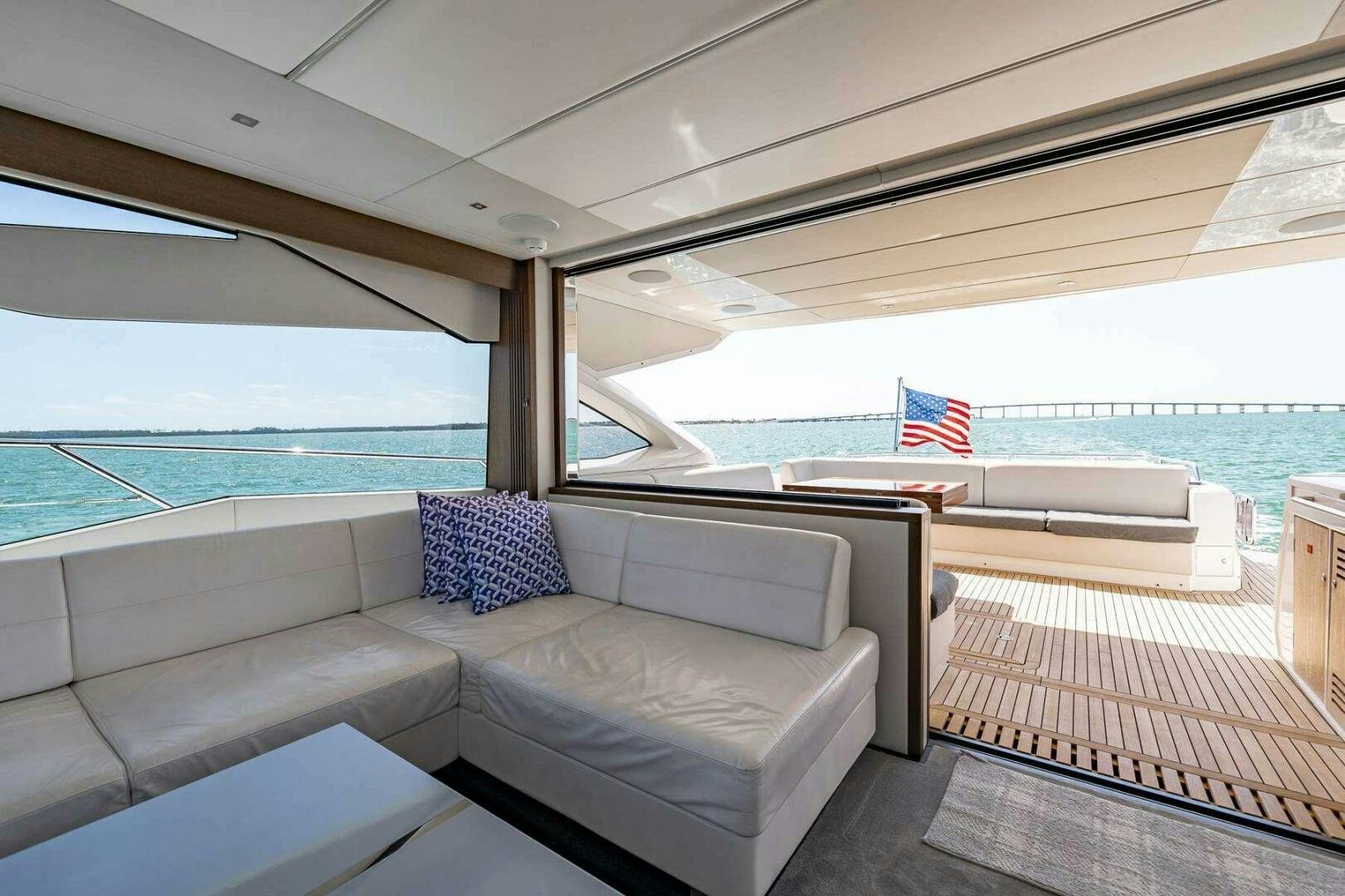 a couch and a table on a boat aboard H Yacht for Sale