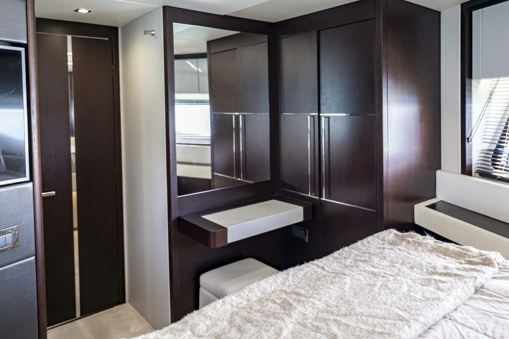 a room with a bed and cabinets aboard H Yacht for Sale