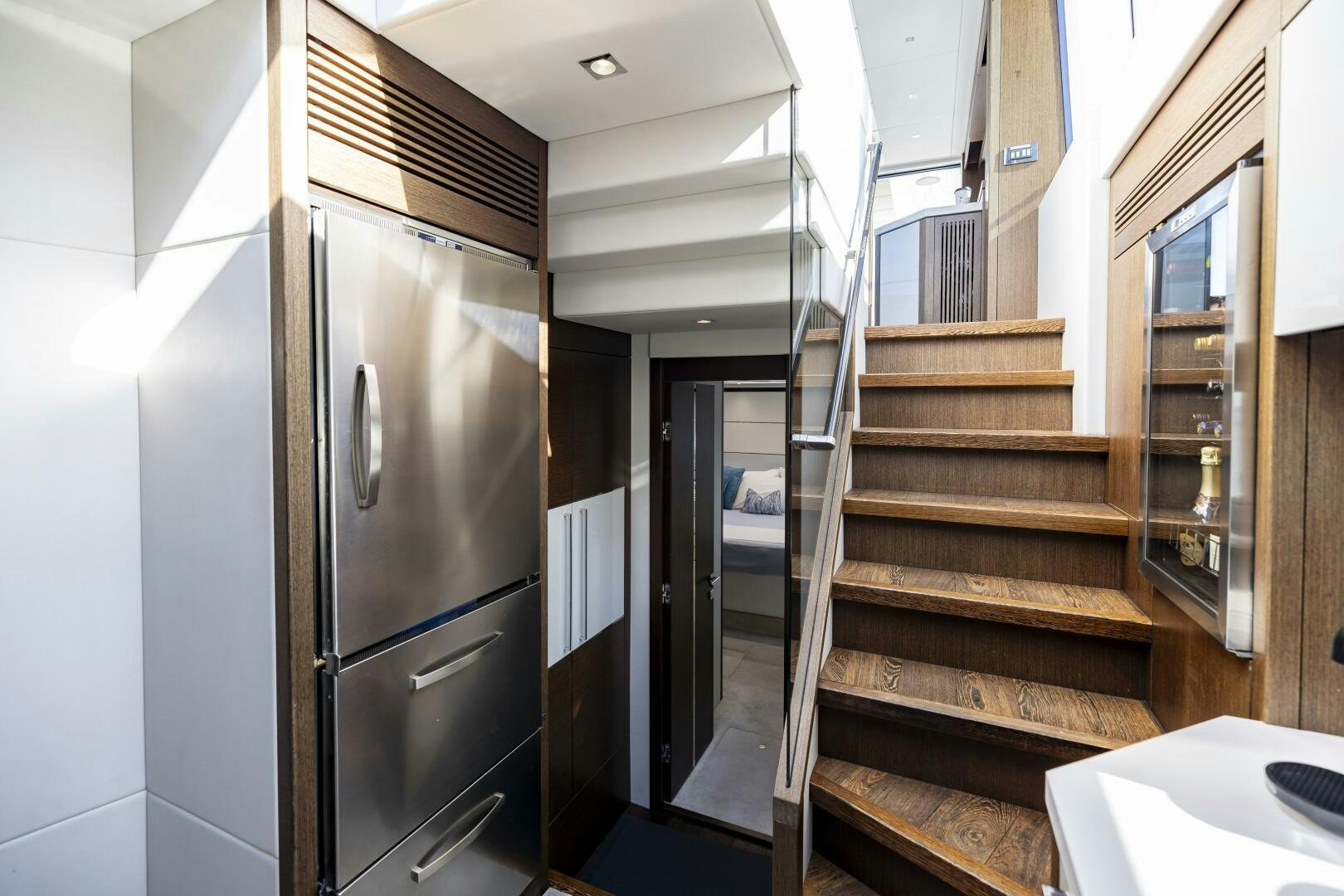 a kitchen with a stainless steel refrigerator aboard H Yacht for Sale