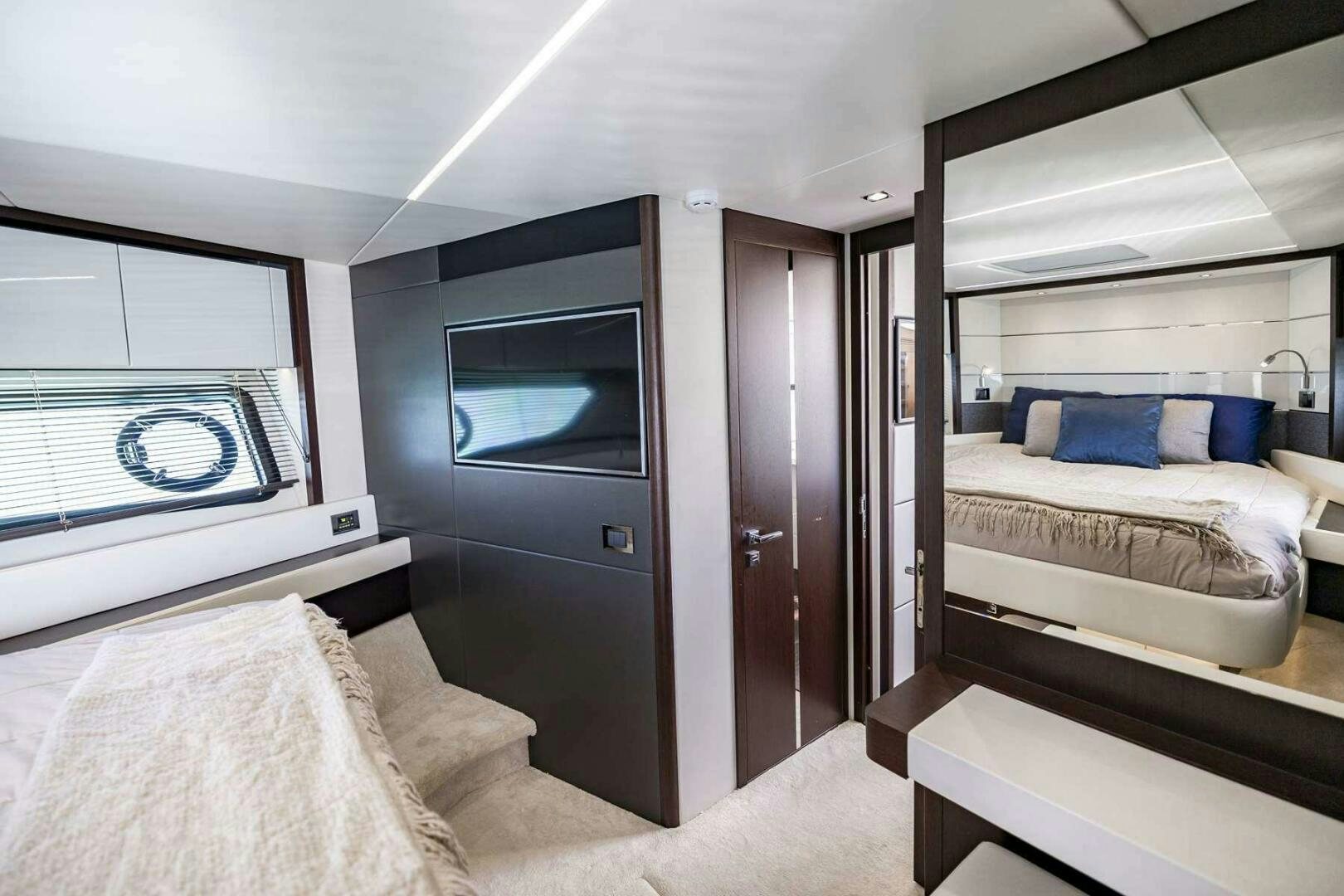 a room with a bed and a television aboard H Yacht for Sale