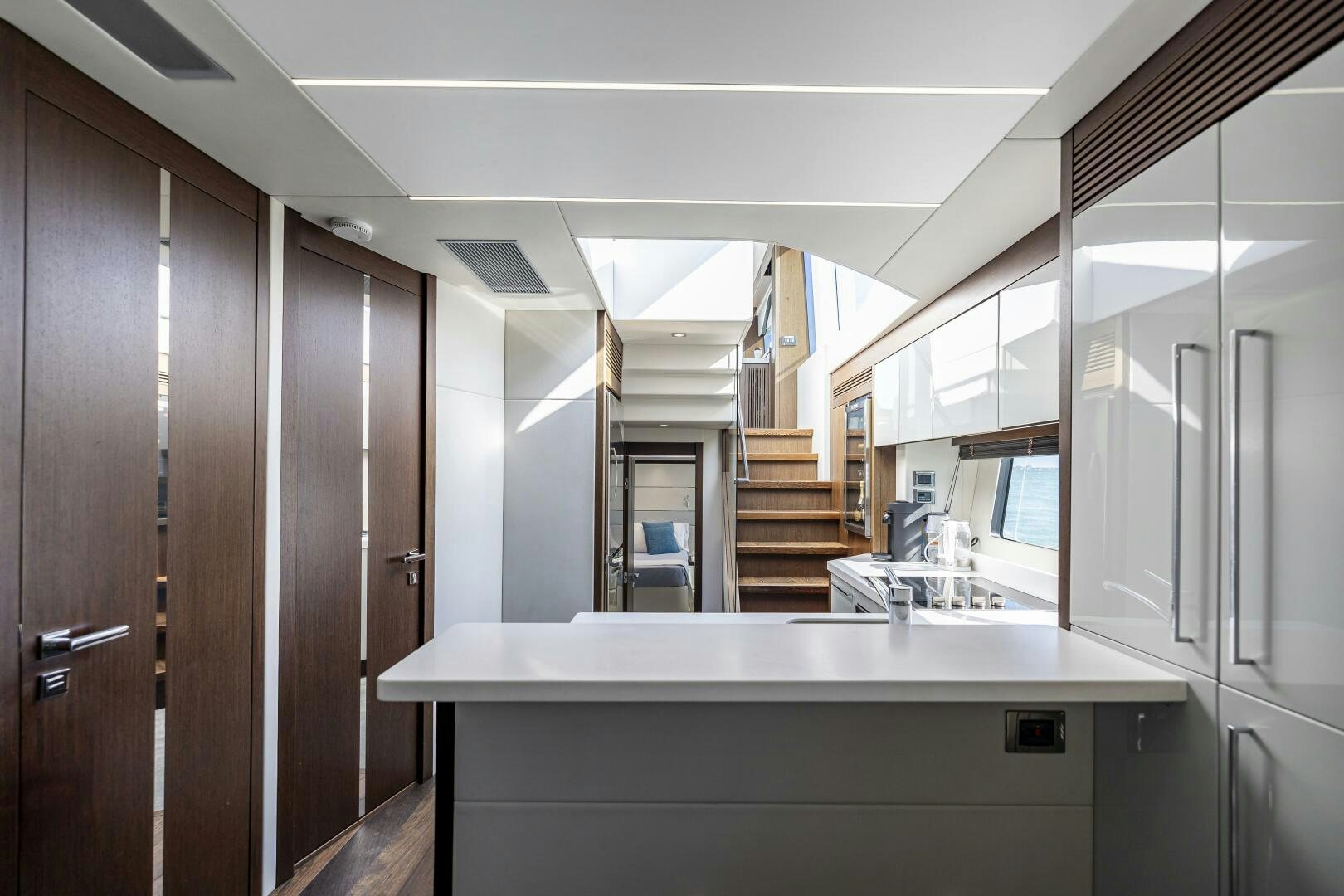 a kitchen with wooden cabinets aboard H Yacht for Sale