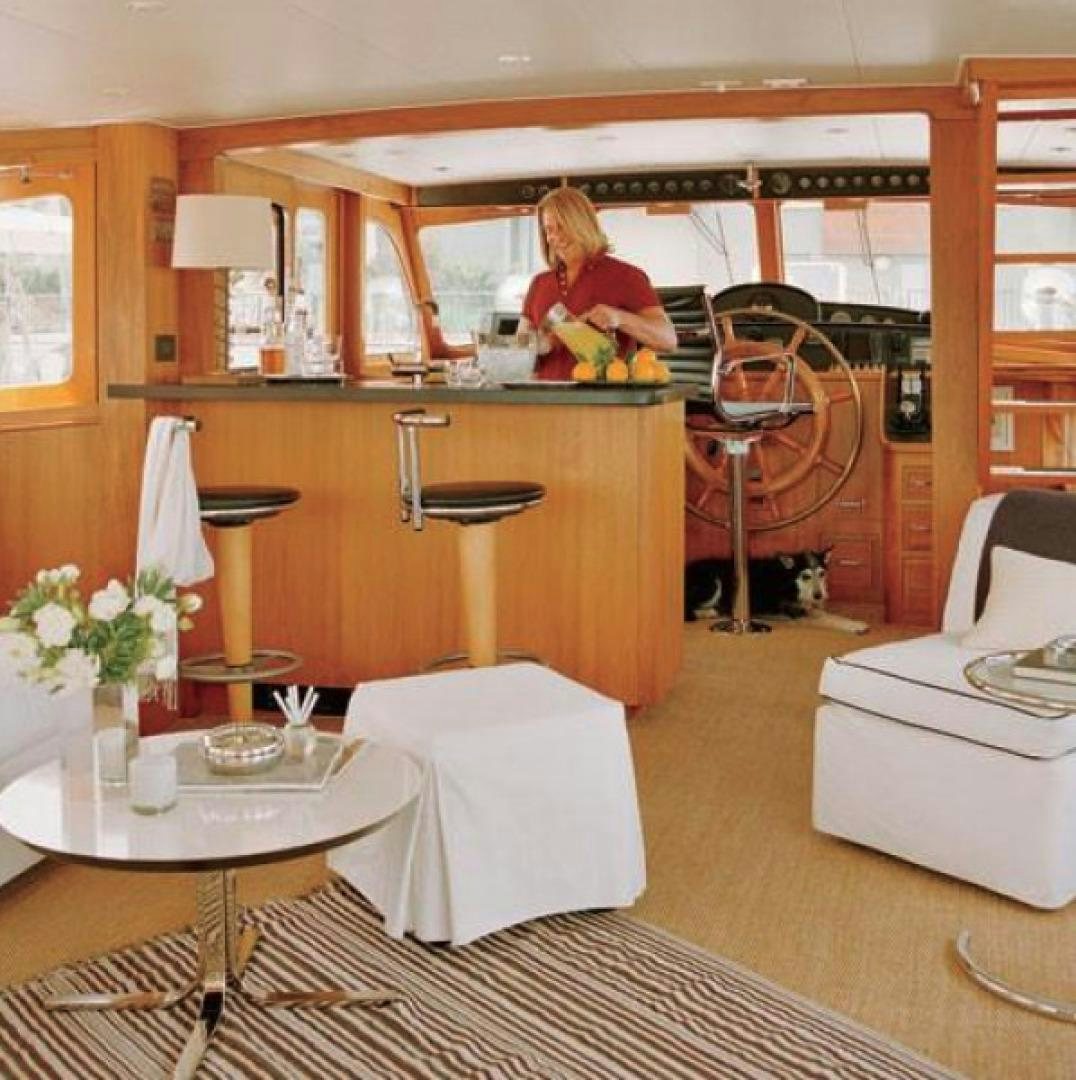 a person sitting at a table aboard DAKOTA Yacht for Sale