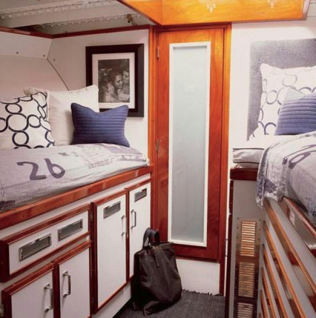 a bedroom with a bed and a backpack aboard DAKOTA Yacht for Sale