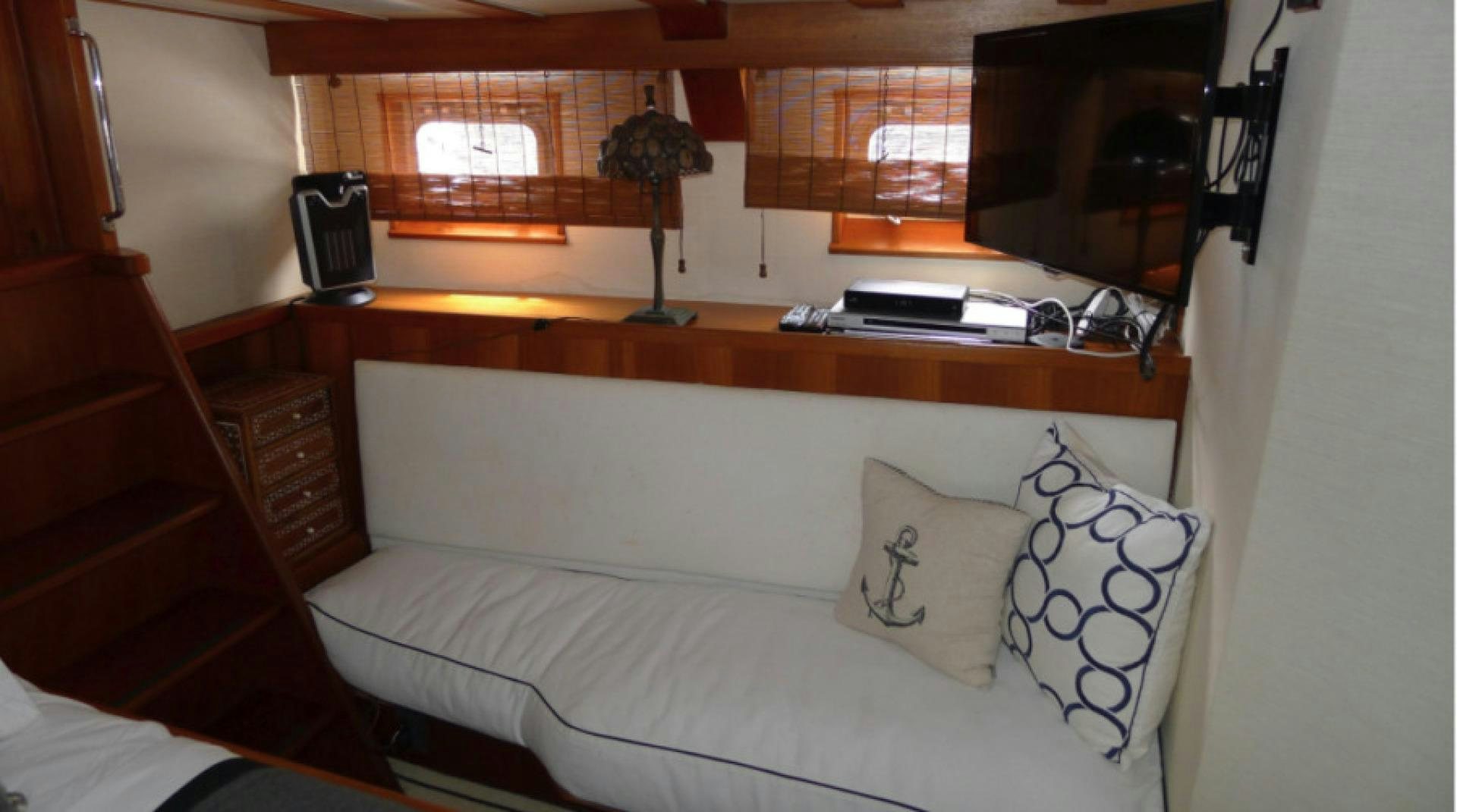 a bed with white sheets and pillows aboard DAKOTA Yacht for Sale