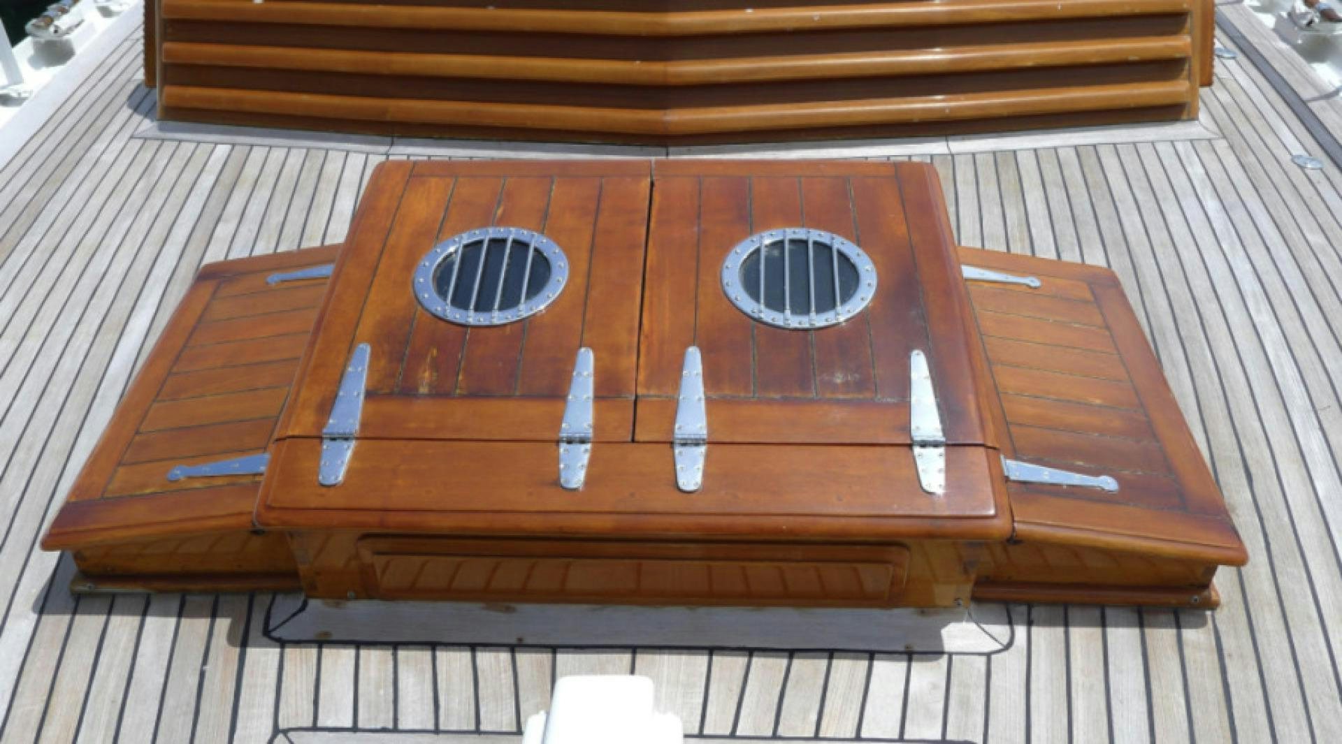 a wooden table with a plate and a knife on it aboard DAKOTA Yacht for Sale